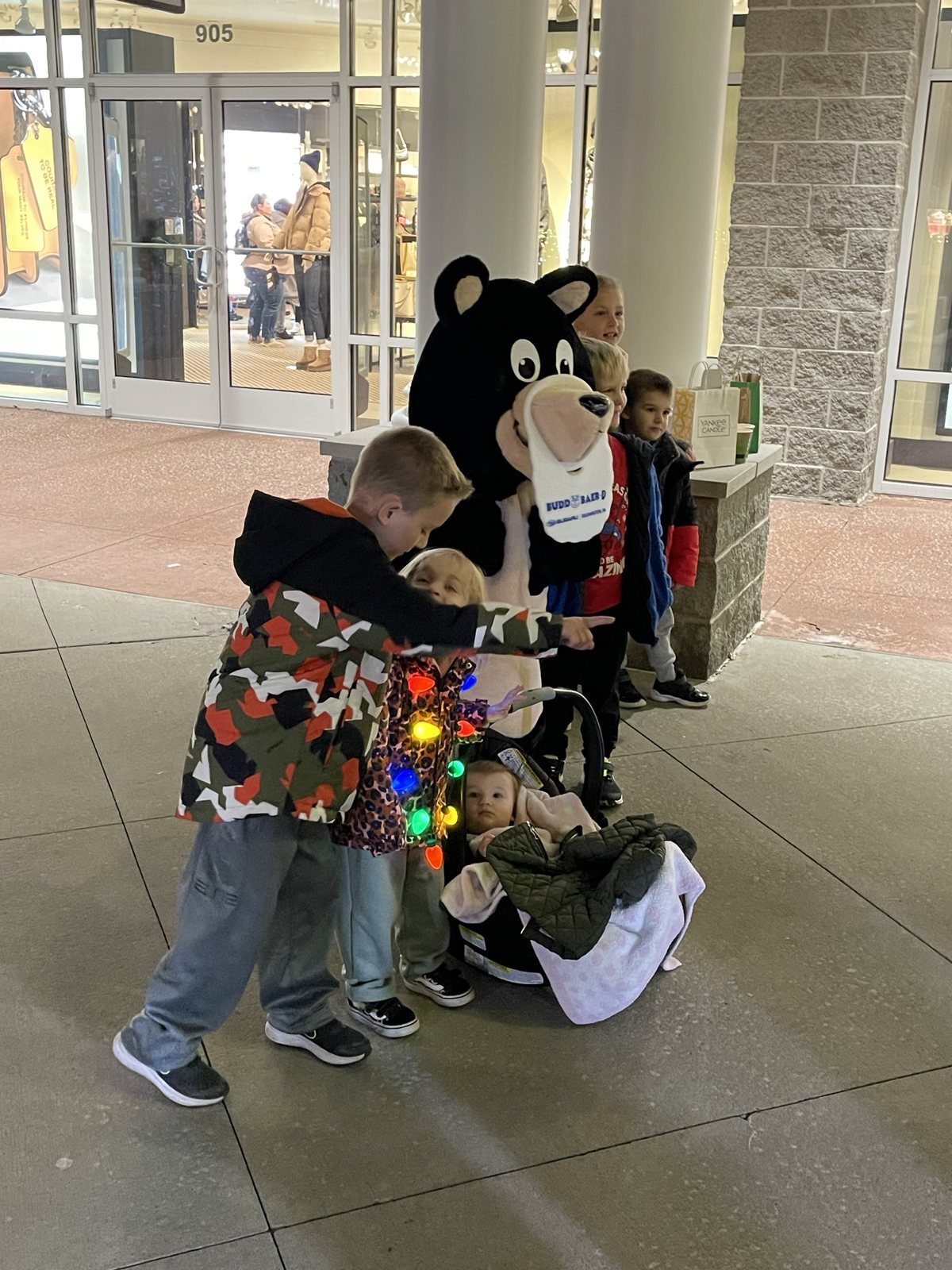 Children meeting the Budd Baer bear mascot at the tree lighting